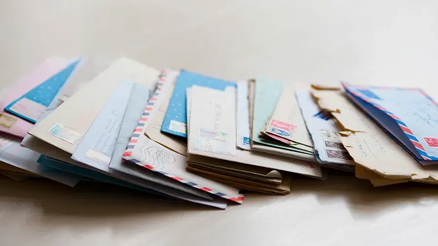 Assorted pieces of mail on a plain background